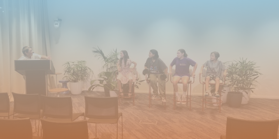 Kids sitting on chairs running their own panel discussion at the ACT 1 event
